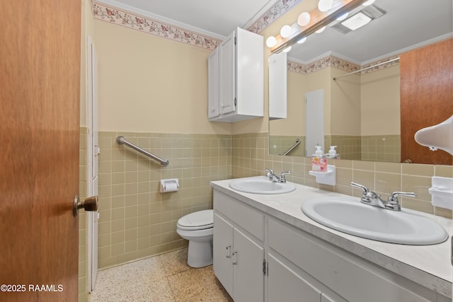 1212 S Main St, Breaux Bridge, LA 70517 - bathroom with double vanity, tile walls, wainscoting, and ornamental molding