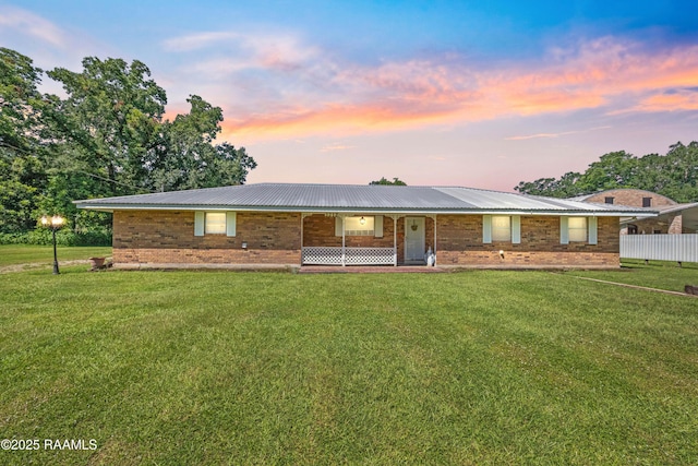 1212 S Main St, Breaux Bridge, LA 70517 - single story home with brick siding, a front yard, and a metal roof