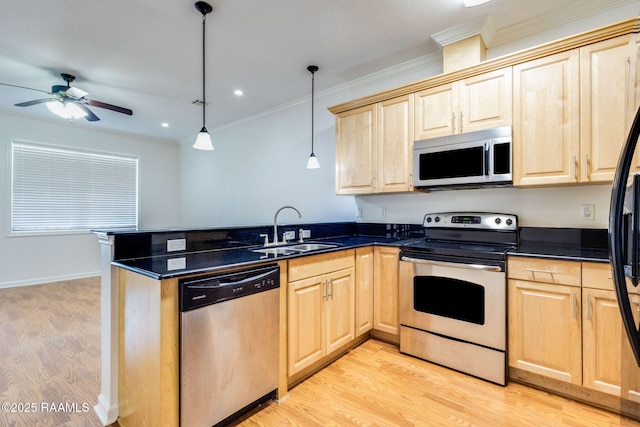 103 Saint Germaine Cir, Lafayette, LA 70506 - kitchen with appliances with stainless steel finishes, light brown cabinetry, a peninsula, light wood-style floors, and ornamental molding