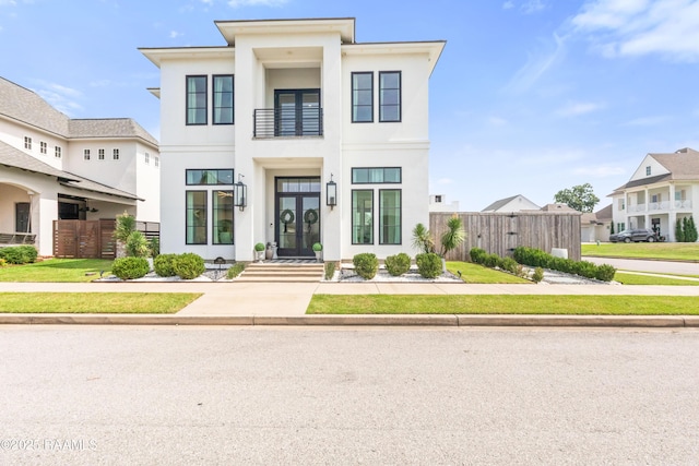 100 Catamaran Dr, Youngsville, LA 70592 - view of front of home with stucco siding and french doors