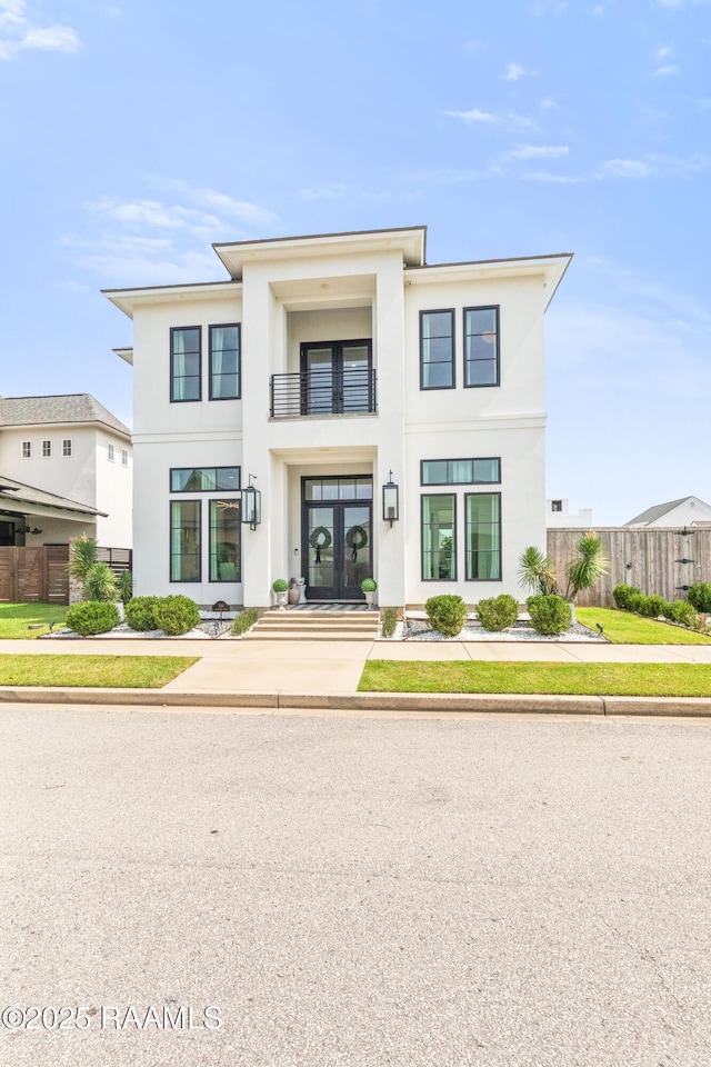 100 Catamaran Dr, Youngsville, LA 70592 - view of front of house featuring french doors, a balcony, and stucco siding
