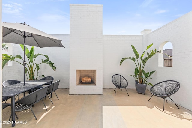 100 Catamaran Dr, Youngsville, LA 70592 - view of patio / terrace with an outdoor brick fireplace and outdoor dining space