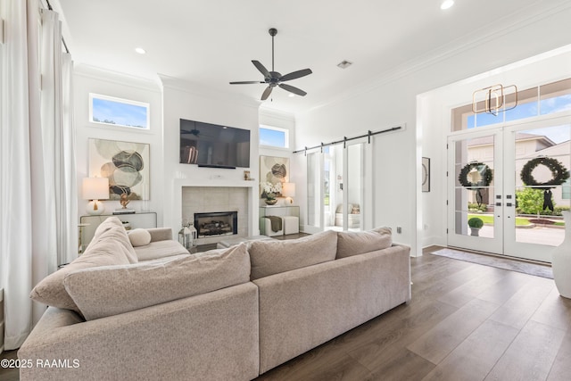 100 Catamaran Dr, Youngsville, LA 70592 - living area with crown molding, healthy amount of natural light, dark wood finished floors, french doors, and a ceiling fan