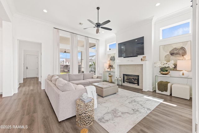 100 Catamaran Dr, Youngsville, LA 70592 - living area with ceiling fan, ornamental molding, a tiled fireplace, recessed lighting, and wood finished floors
