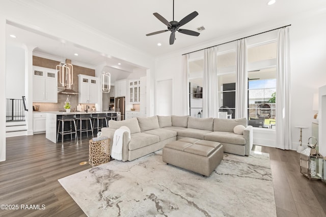 100 Catamaran Dr, Youngsville, LA 70592 - living area featuring dark wood-type flooring, recessed lighting, a ceiling fan, and crown molding