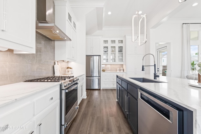 100 Catamaran Dr, Youngsville, LA 70592 - kitchen with stainless steel appliances, wall chimney exhaust hood, white cabinets, dark wood finished floors, and light stone countertops