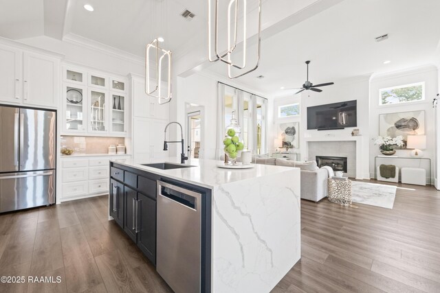 100 Catamaran Dr, Youngsville, LA 70592 - kitchen with appliances with stainless steel finishes, white cabinets, ceiling fan, dark wood finished floors, and crown molding