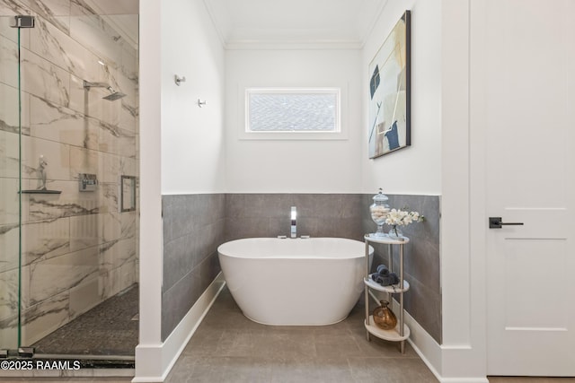 100 Catamaran Dr, Youngsville, LA 70592 - full bath featuring a marble finish shower, a soaking tub, tile walls, crown molding, and a wainscoted wall