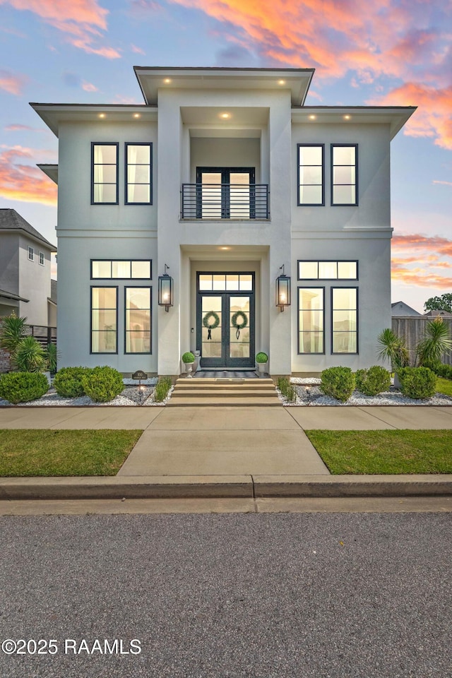 100 Catamaran Dr, Youngsville, LA 70592 - view of front of house featuring a balcony, stucco siding, and french doors