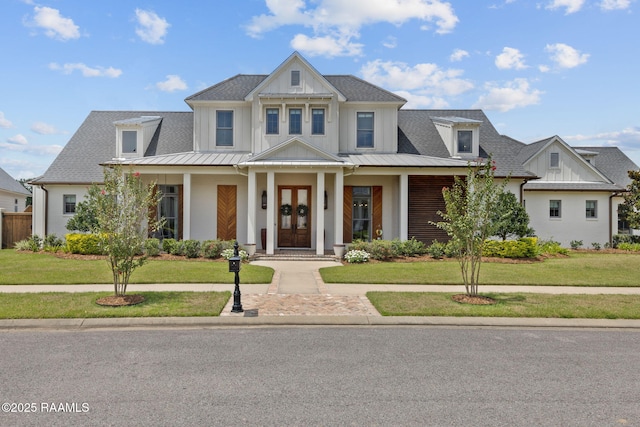 106 Sonoma Way, Lafayette, LA 70508 - view of front of home featuring a front lawn, a standing seam roof, board and batten siding, and a metal roof