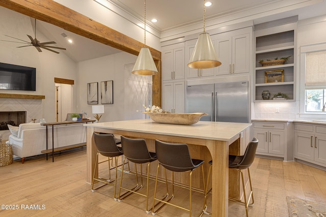 106 Sonoma Way, Lafayette, LA 70508 - kitchen with stainless steel built in fridge, a kitchen island, light wood-style flooring, open floor plan, and light countertops