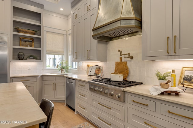 106 Sonoma Way, Lafayette, LA 70508 - kitchen featuring custom range hood, stainless steel appliances, tasteful backsplash, light wood-style flooring, and open shelves
