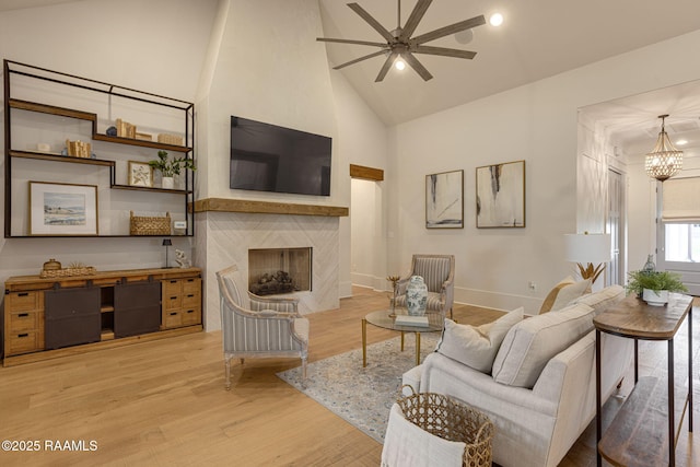 106 Sonoma Way, Lafayette, LA 70508 - living area with high vaulted ceiling, ceiling fan, light wood-style flooring, a premium fireplace, and a chandelier