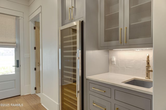 106 Sonoma Way, Lafayette, LA 70508 - bar area featuring wine cooler, backsplash, and light wood finished floors