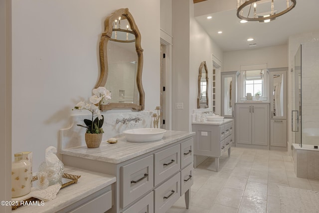 106 Sonoma Way, Lafayette, LA 70508 - full bath featuring two vanities, a tile shower, tile patterned flooring, a chandelier, and recessed lighting