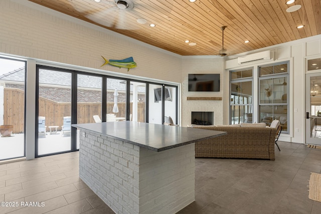 106 Sonoma Way, Lafayette, LA 70508 - kitchen with wood ceiling, recessed lighting, a wall mounted AC, a fireplace, and a center island