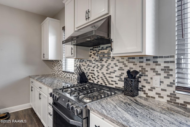 213 E Peck Blvd, Lafayette, LA 70508 - kitchen with gas stove, under cabinet range hood, white cabinets, and light stone counters