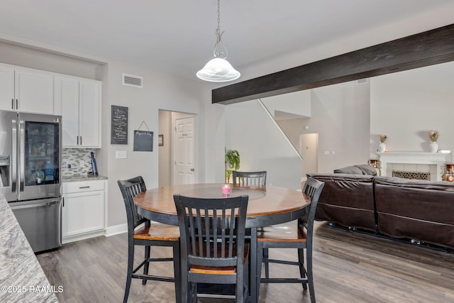 213 E Peck Blvd, Lafayette, LA 70508 - dining space featuring light wood-style flooring and a tiled fireplace