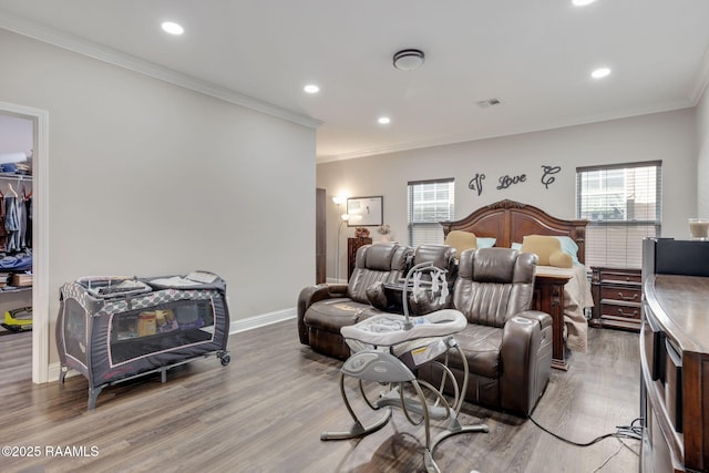 213 E Peck Blvd, Lafayette, LA 70508 - bedroom with light wood-style flooring, crown molding, recessed lighting, a walk in closet, and a closet