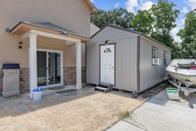 213 E Peck Blvd, Lafayette, LA 70508 - property entrance with brick siding, roof with shingles, a patio area, and cooling unit