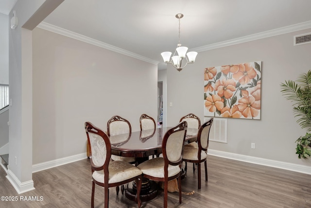 213 E Peck Blvd, Lafayette, LA 70508 - dining room featuring wood finished floors, crown molding, and a chandelier
