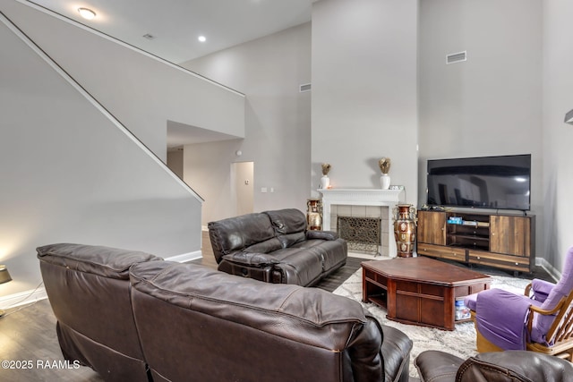 213 E Peck Blvd, Lafayette, LA 70508 - living area with a high ceiling, wood finished floors, a tile fireplace, and stairs