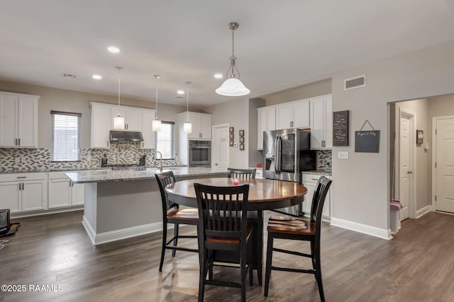 213 E Peck Blvd, Lafayette, LA 70508 - dining room featuring recessed lighting, plenty of natural light, and dark wood-style floors