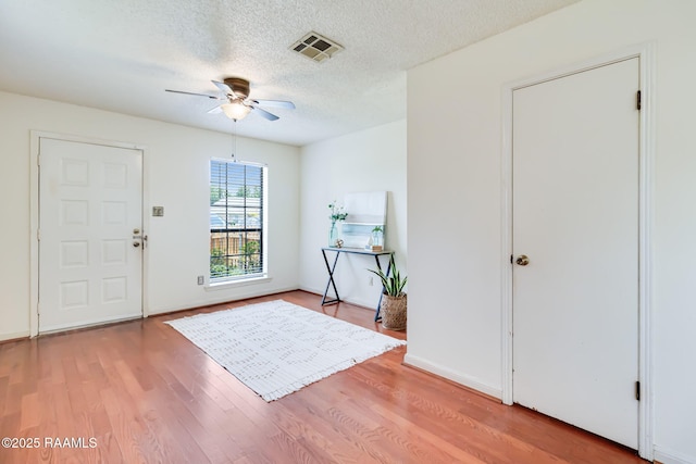 2421 Robley Dr, Lafayette, LA 70503 - entrance foyer featuring a ceiling fan, wood finished floors, and a textured ceiling