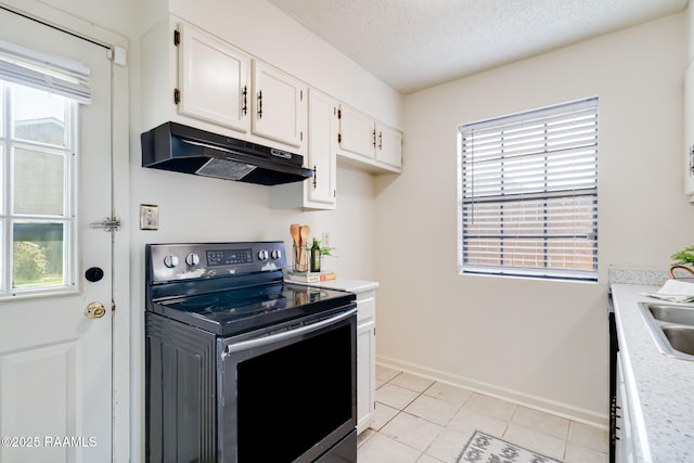 2421 Robley Dr, Lafayette, LA 70503 - kitchen featuring stainless steel range with electric cooktop, under cabinet range hood, white cabinets, light countertops, and a textured ceiling
