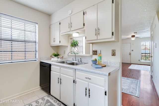 2421 Robley Dr, Lafayette, LA 70503 - kitchen featuring dishwasher, a textured ceiling, light countertops, white cabinets, and ceiling fan