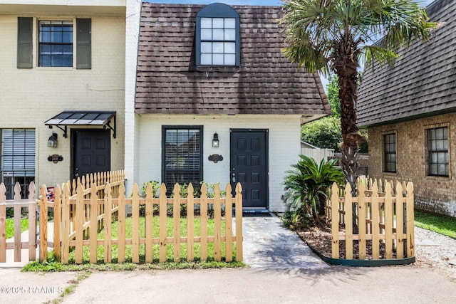 2421 Robley Dr, Lafayette, LA 70503 - view of front of property with brick siding, mansard roof, and a shingled roof