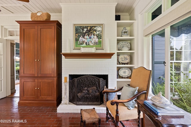 6302 Old Jeanerette Rd, New Iberia, LA 70563 - living area with crown molding, built in features, and a brick fireplace