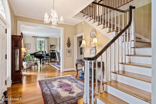 6302 Old Jeanerette Rd, New Iberia, LA 70563 - entryway featuring ornamental molding, wood finished floors, a chandelier, and stairway