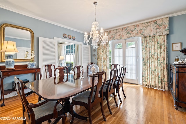 6302 Old Jeanerette Rd, New Iberia, LA 70563 - dining area with a chandelier, plenty of natural light, crown molding, and light wood-type flooring