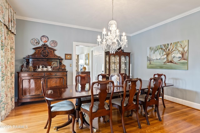6302 Old Jeanerette Rd, New Iberia, LA 70563 - dining area featuring light wood-style floors, a chandelier, and ornamental molding