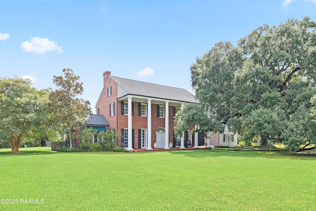6302 Old Jeanerette Rd, New Iberia, LA 70563 - neoclassical / greek revival house featuring a front lawn, a chimney, and brick siding