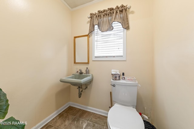 118 Garrigue Dr, Opelousas, LA 70570 - bathroom with toilet and crown molding