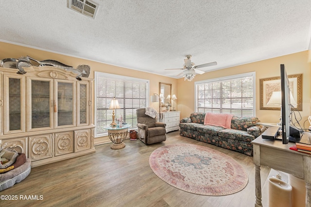 118 Garrigue Dr, Opelousas, LA 70570 - living room featuring a textured ceiling, wood finished floors, and ceiling fan