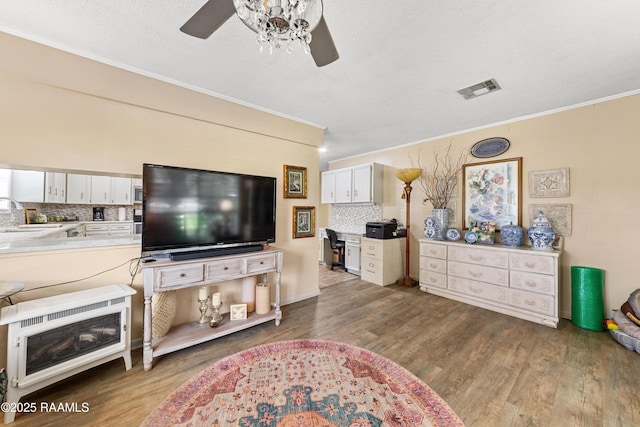 118 Garrigue Dr, Opelousas, LA 70570 - living room with ceiling fan, crown molding, and wood finished floors