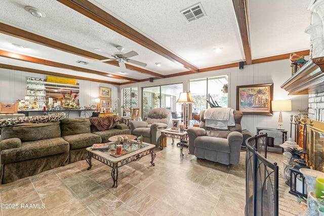 118 Garrigue Dr, Opelousas, LA 70570 - living room with a ceiling fan, beam ceiling, a textured ceiling, a fireplace, and wooden walls