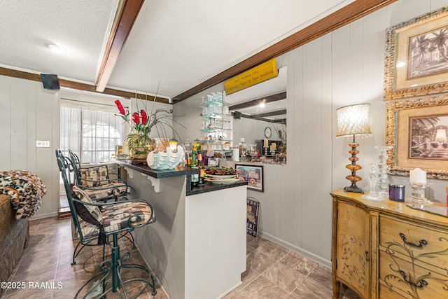 118 Garrigue Dr, Opelousas, LA 70570 - bar area with a decorative wall, beam ceiling, and a textured ceiling