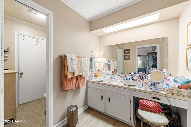 118 Garrigue Dr, Opelousas, LA 70570 - bathroom featuring a skylight, crown molding, vanity, and a textured ceiling