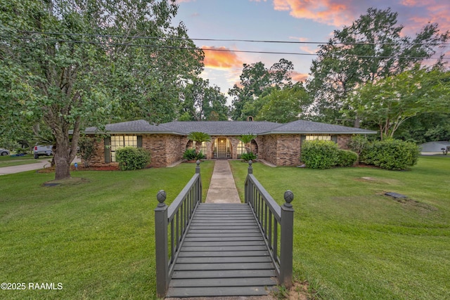 118 Garrigue Dr, Opelousas, LA 70570 - view of front of property featuring brick siding and a front yard