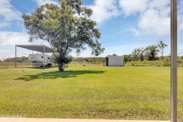 307 Bertrand Rd, Opelousas, LA 70570 - view of green lawn with a carport and a storage shed