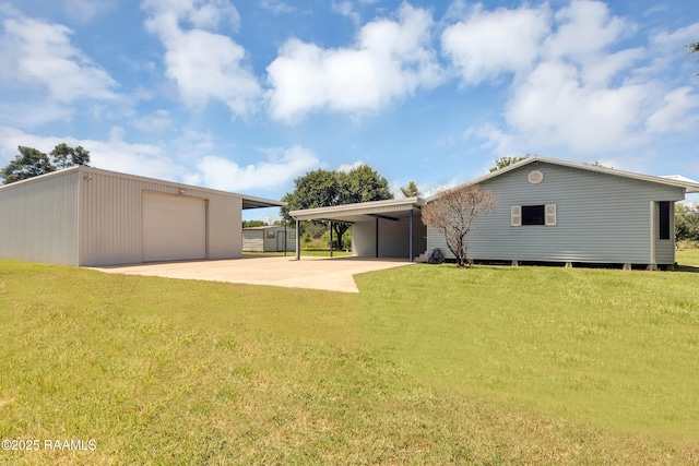 307 Bertrand Rd, Opelousas, LA 70570 - back of property featuring an outbuilding, a lawn, and concrete driveway