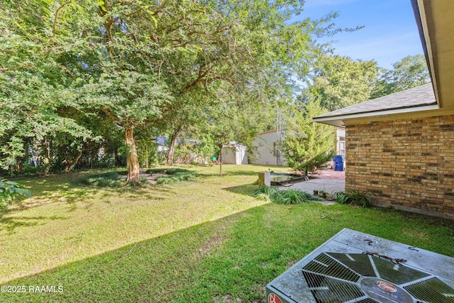 1912 Mimosa St, Abbeville, LA 70510 - view of green lawn with a patio and an outdoor structure