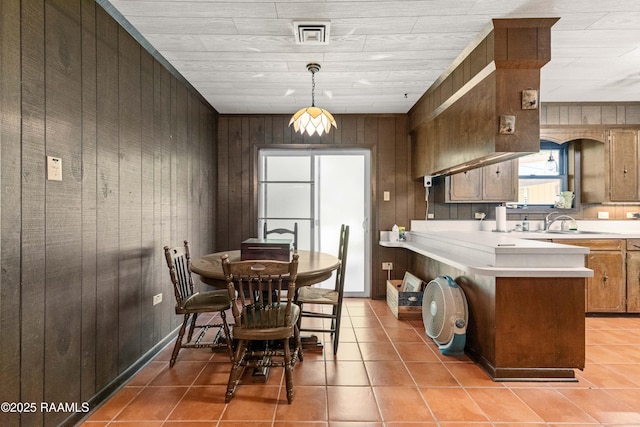 1912 Mimosa St, Abbeville, LA 70510 - dining space featuring wood walls and light tile patterned floors