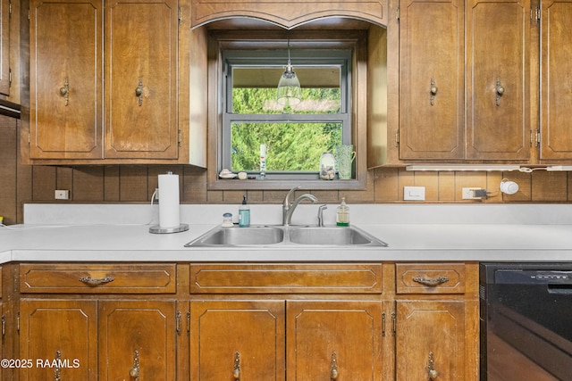 1912 Mimosa St, Abbeville, LA 70510 - kitchen featuring dishwasher, light countertops, and brown cabinetry