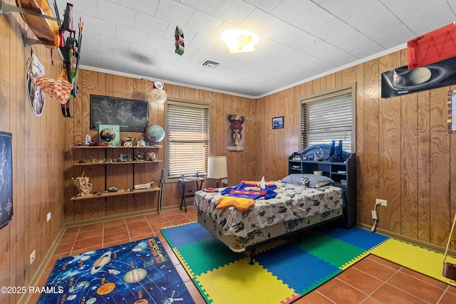 1912 Mimosa St, Abbeville, LA 70510 - bedroom featuring tile patterned flooring, wooden walls, and crown molding