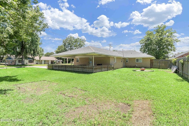 101 Barrow St, New Iberia, LA 70563 - rear view of property with an outdoor fire pit, a fenced backyard, and brick siding